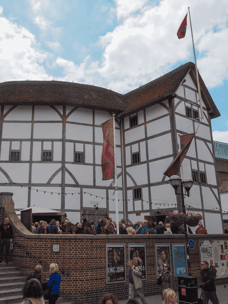 Authentic Tudor-style building at Quest For Directions with crowd and banners.