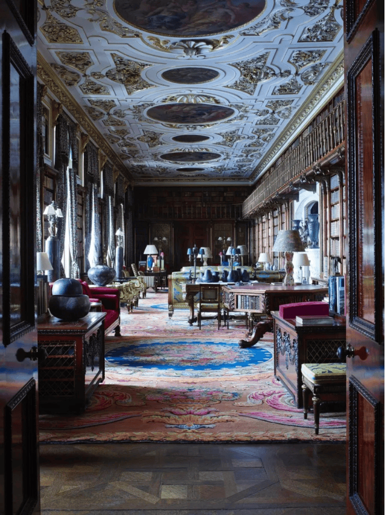 Luxurious historic library interior with ornate ceiling, antique furniture, and elegant décor, showcasing classic design and opulence.