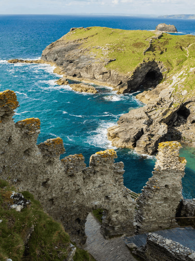 Stunning coastal cliffs and ancient ruins overlooking the Atlantic Ocean in summer.