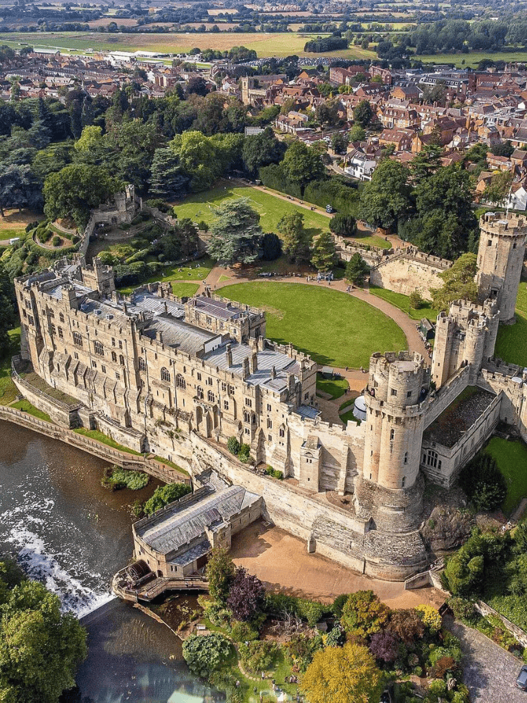 1. Beautiful aerial view of Warwick Castle in England, historic medieval fortress and popular tourist attraction.