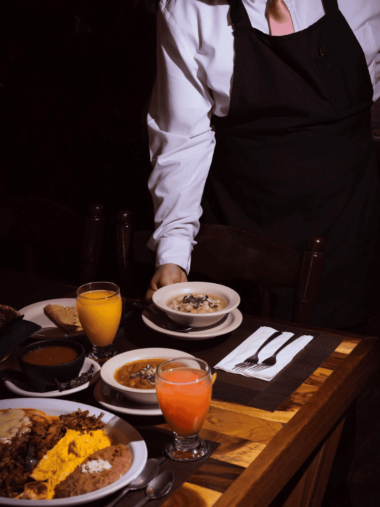 Freshly prepared traditional dishes served with colorful beverages in a cozy restaurant setting.