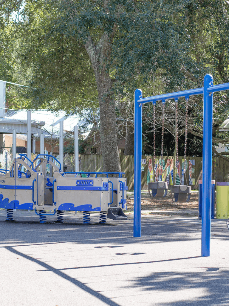 Colorful playground equipment for children at Quest for Directions community park, outdoor play area.