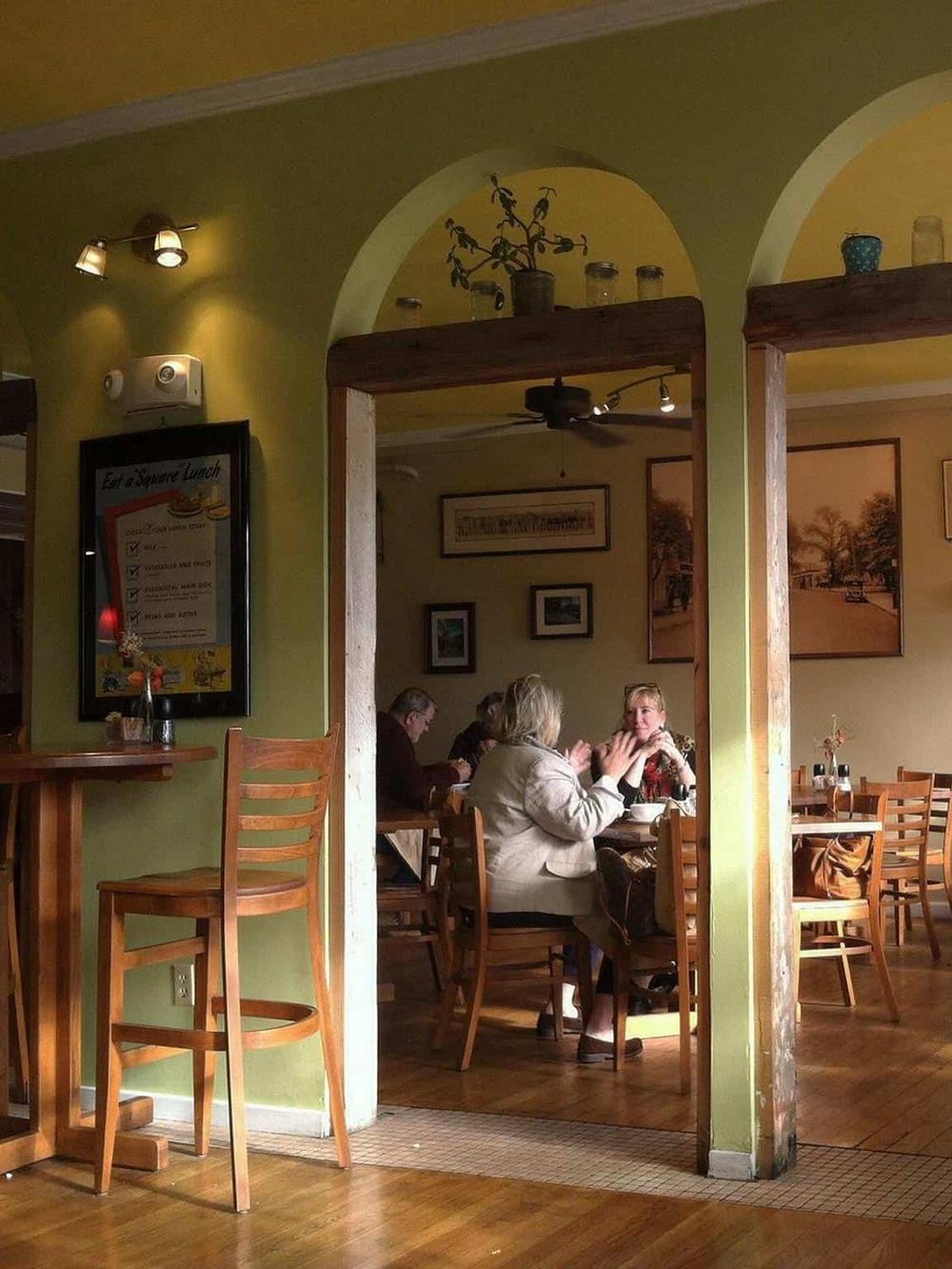Cozy restaurant interior with customers enjoying their meal, warm lighting, and rustic decor at QuestForDirections.