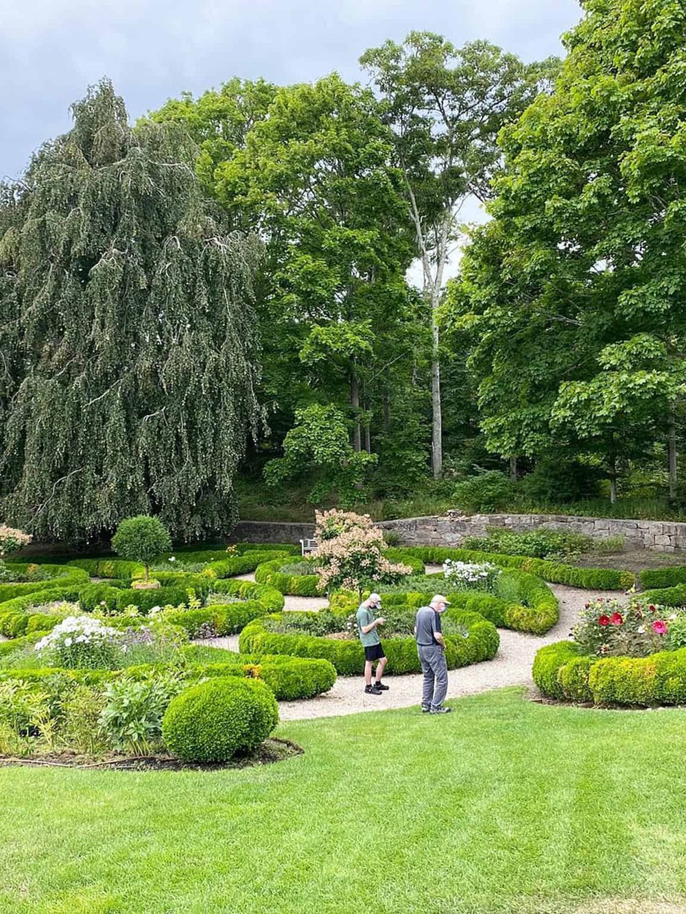 Lush garden with topiary and blooming flowers, ideal for outdoor exploration and nature walks.