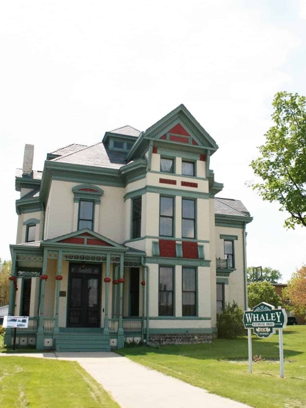 Colorful Victorian-style house with detailed trim and a welcoming porch.