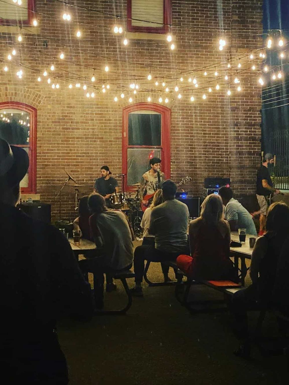 Live music performance at Quest For Directions outdoor venue during evening.