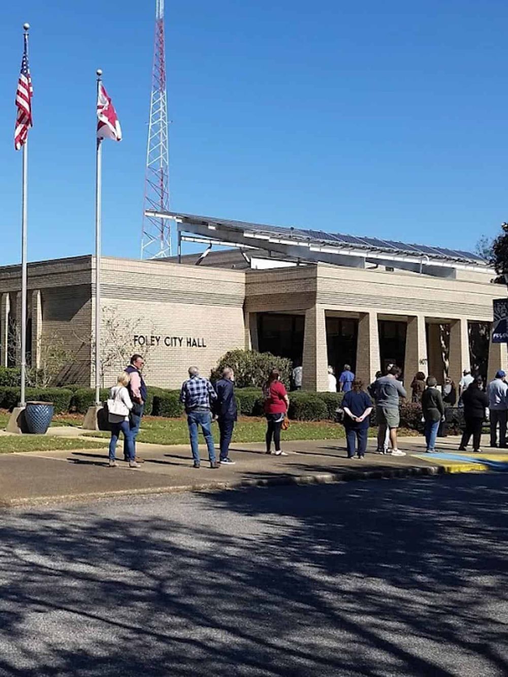 People waiting outside Foley City Hall, demonstrating community engagement and local government services.