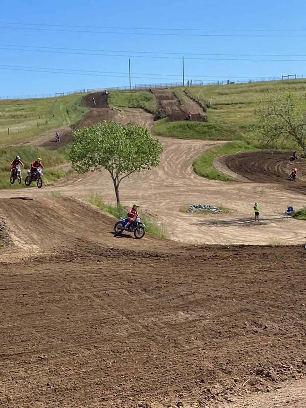 Motocross riders on dirt track at QuestForDirections, outdoor adventure sports, and off-road motorcycle riding.