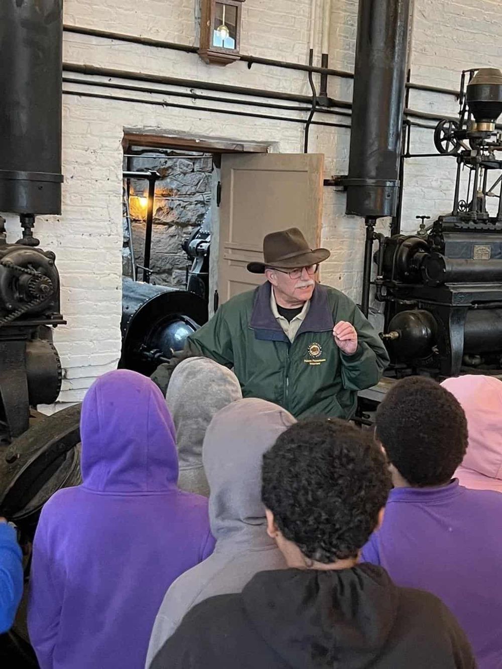 Historic steam engine tour at QuestForDirections train museum, engaging visitors with industrial history.