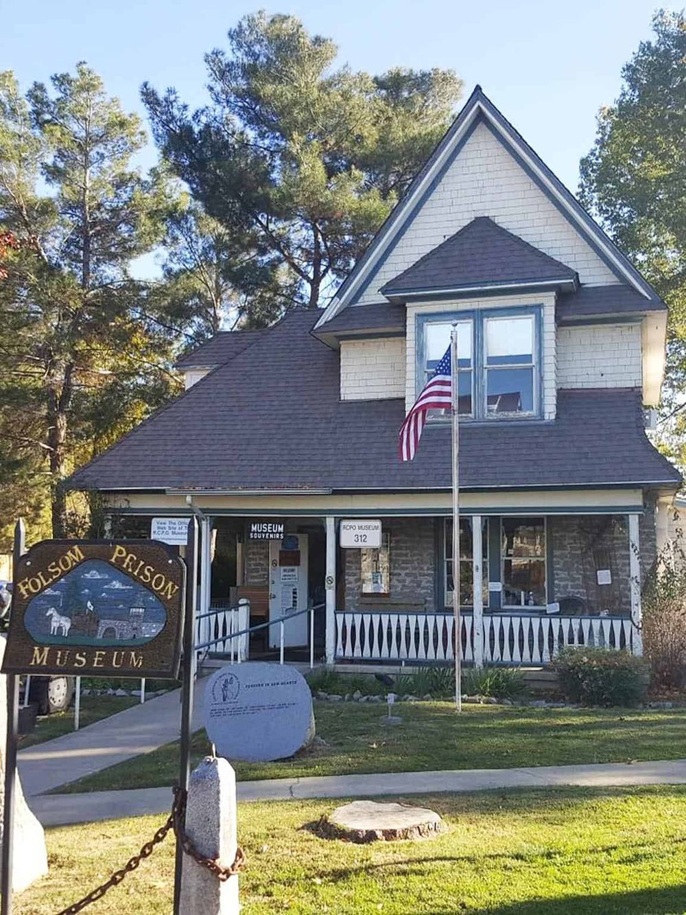 Vintage house museum with American flag, historical exhibits, and scenic surroundings.