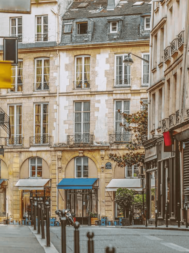 Quiet Paris street with classic architecture and cafes, perfect for sightseeing and exploring historic neighborhoods.