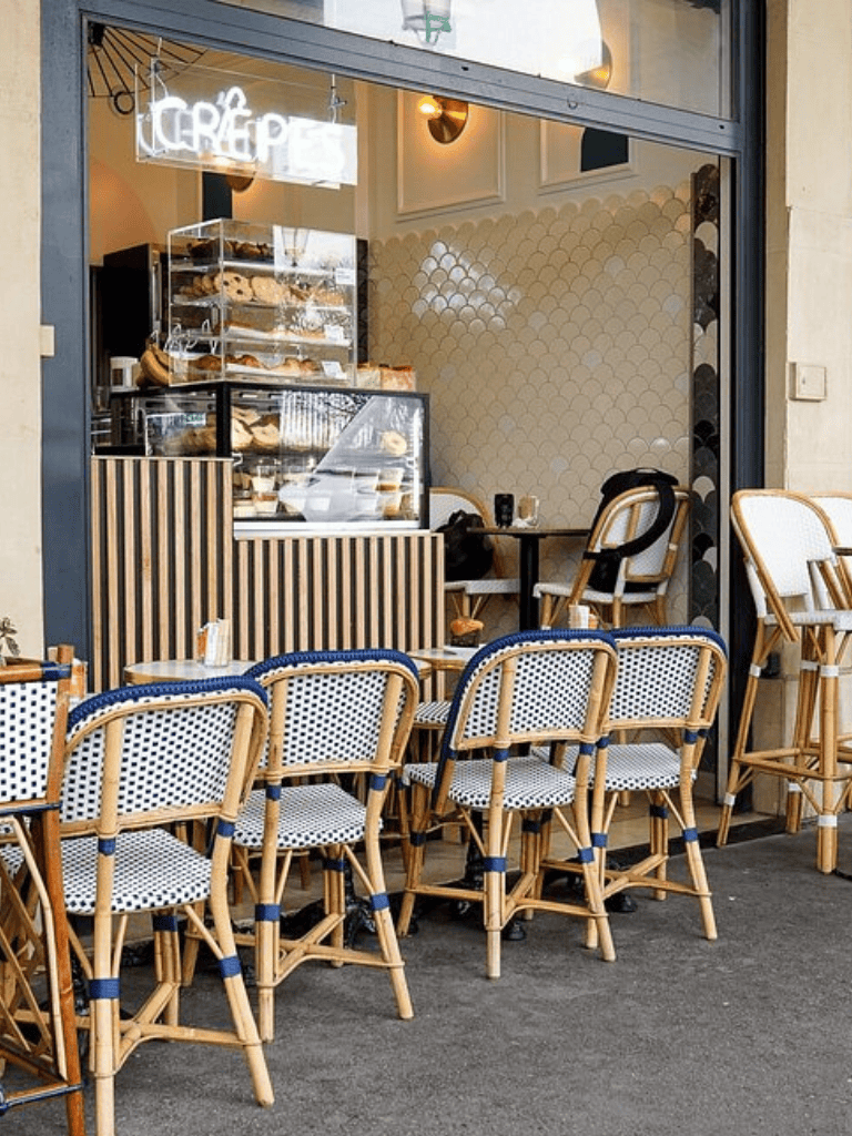 Cafe bakery with outdoor seating and modern decor, perfect for enjoying gourmet pastries and coffee in Paris.
