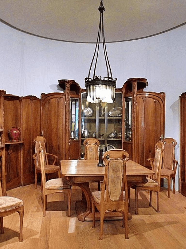 Elegant wooden dining room table with six upholstered chairs, antique china cabinet, vintage chandelier, classic home decor.