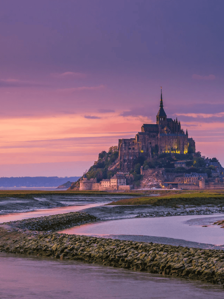 Majestic Mont Saint-Michel at sunset, iconic travel destination in Normandy France.