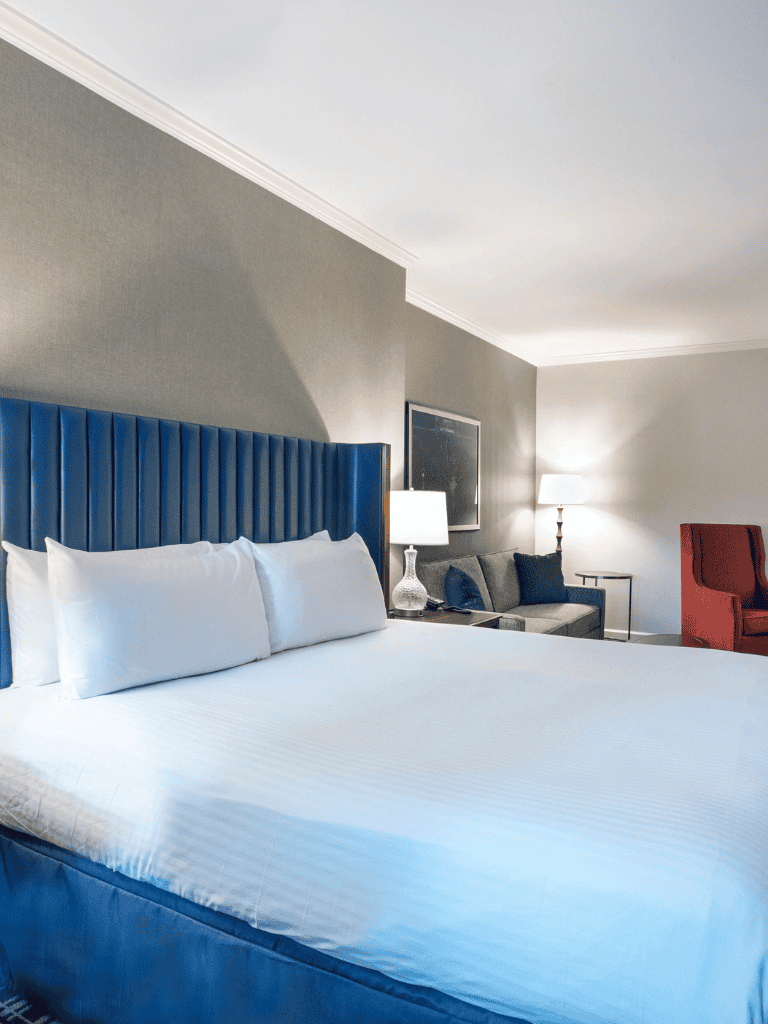 Comfortable hotel bedroom with modern decor, large bed, and stylish lighting for a relaxing stay.
