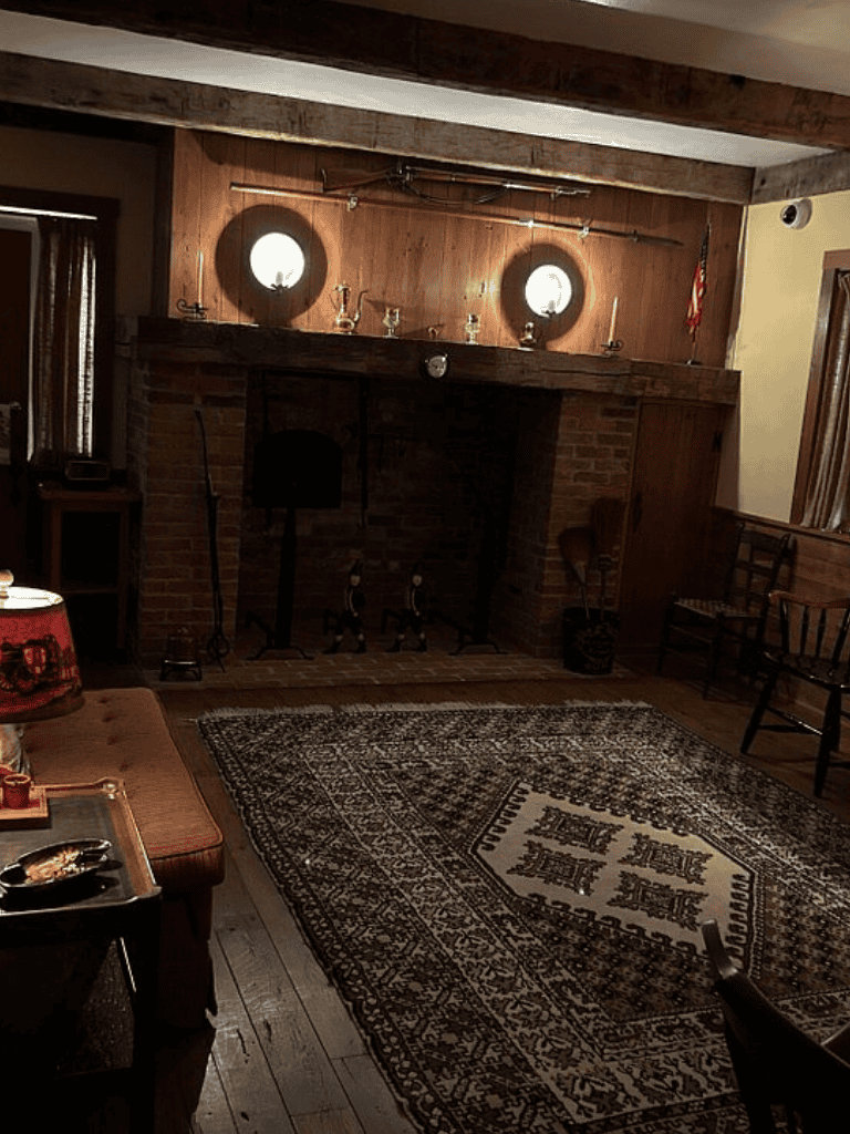 Cozy rustic living room with brick fireplace and vintage decor, perfect for relaxation and storytelling.