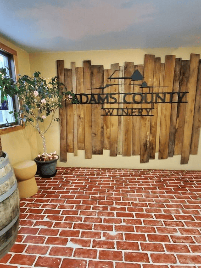 Luxurious winery interior with rustic wooden decor and red brick flooring at Adams County Winery.
