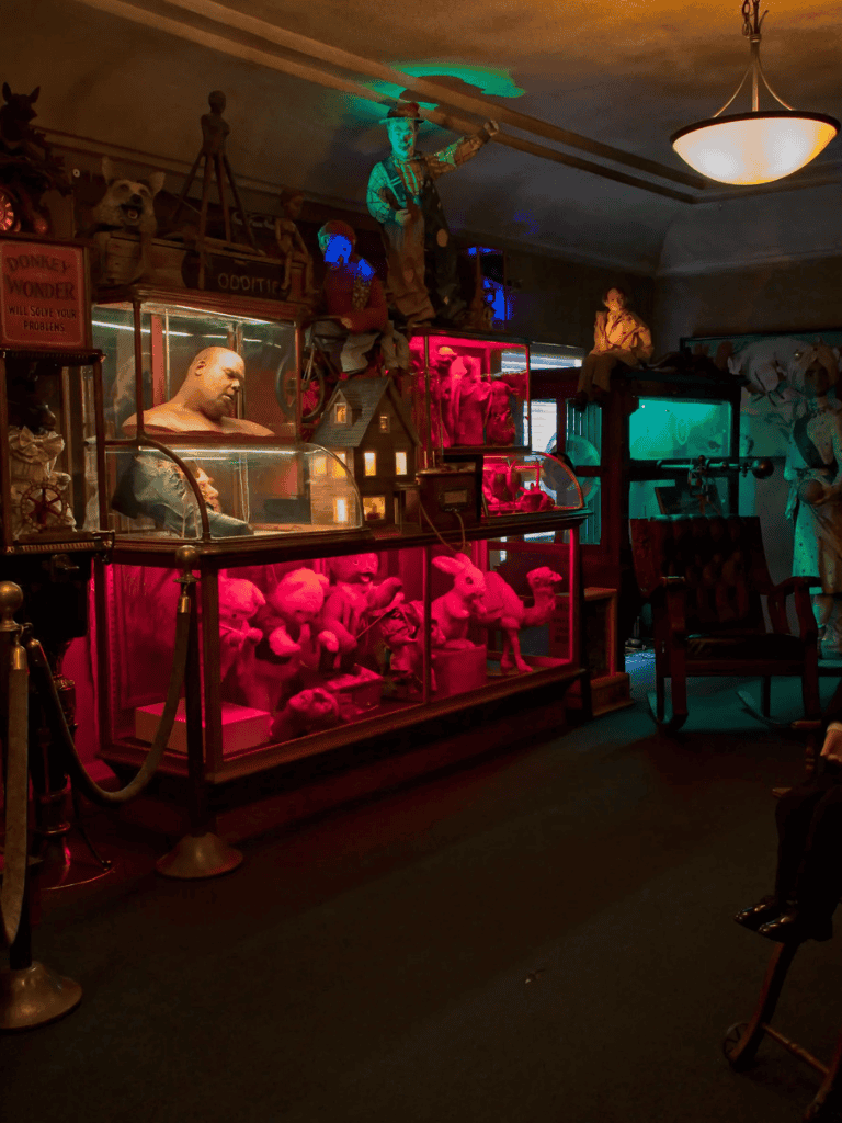 Colorful vintage toy and doll display in themed antique store or museum.