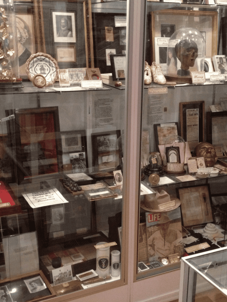 Vintage historical artifacts display case at QuestForDirections, showcasing unique collectibles.