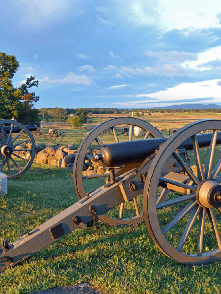 Cannons on historic battlefield with open sky and landscape, Perfect for historical site exploration and educational tours.