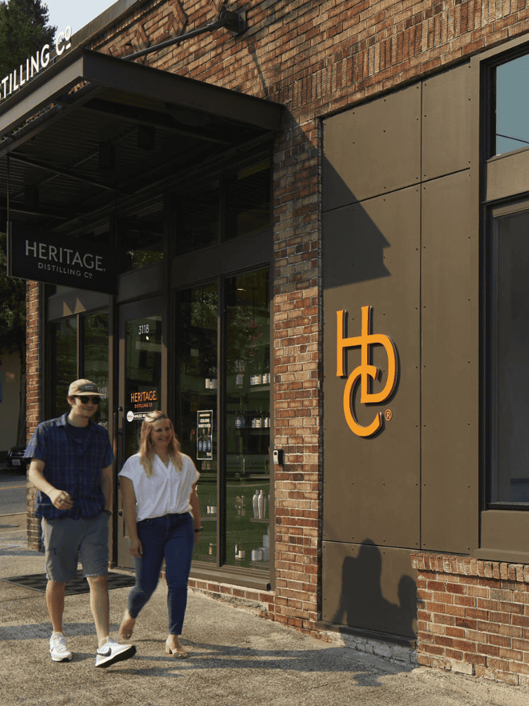 Heritage Distilling Co storefront, cozy local distillery in a brick building with visitors.