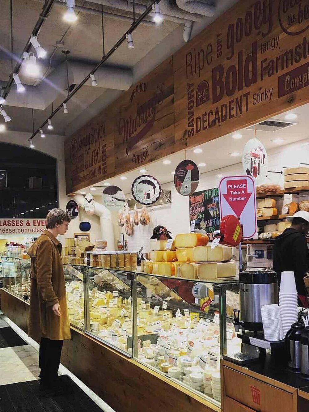Artisan cheese shop interior showcasing a wide variety of cheeses in a specialty store.