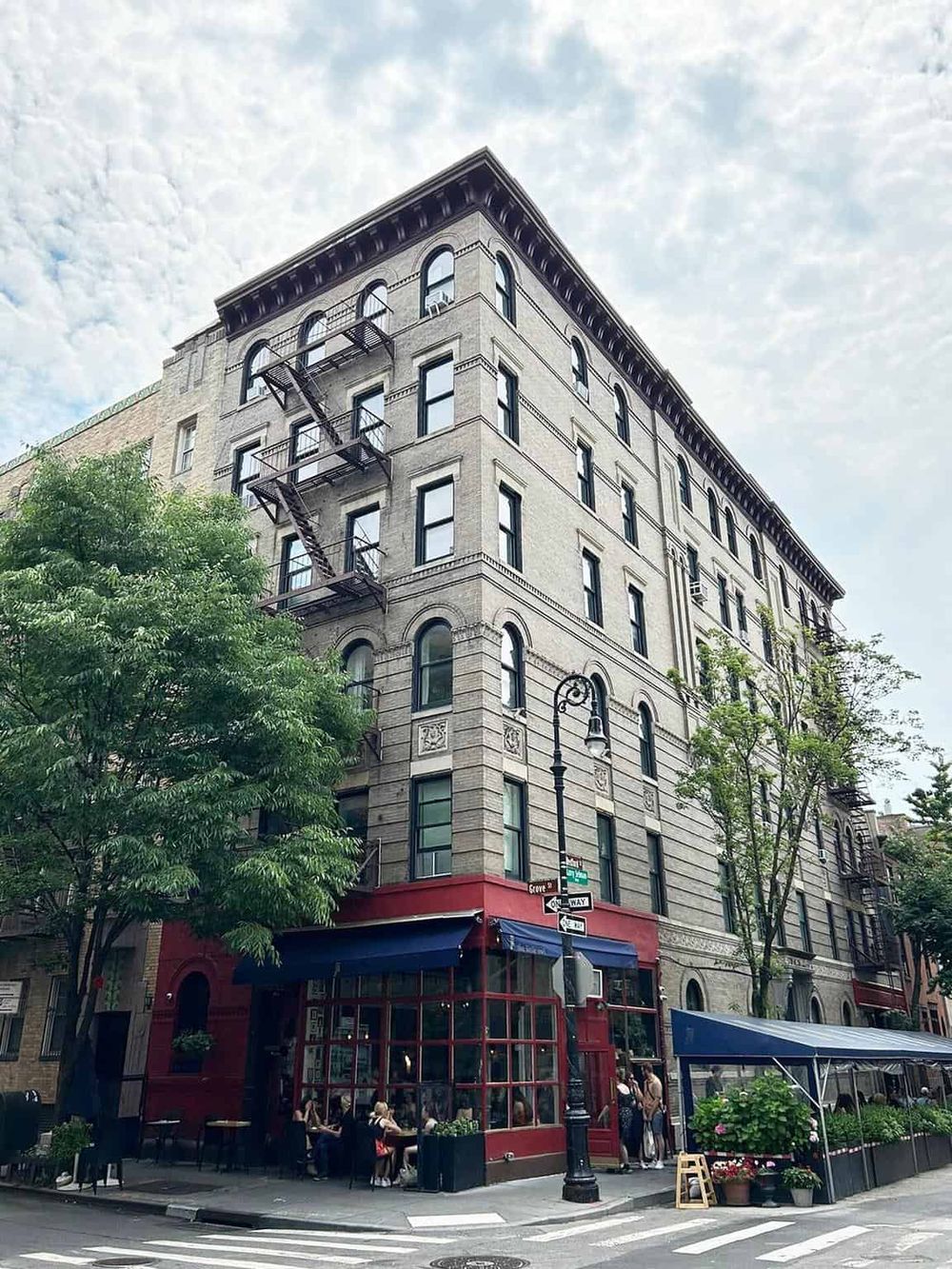 Historic brick building with outdoor seating near city street, downtown architecture.