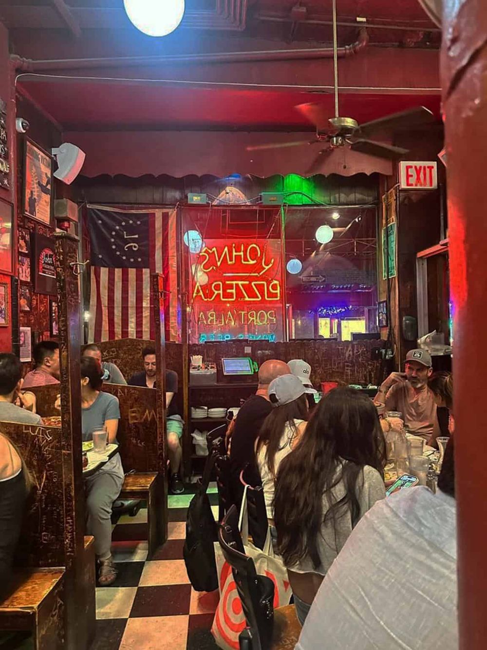 Vibrant, cozy restaurant interior filled with diverse diners, neon signage, vintage decor, and an inviting atmosphere.