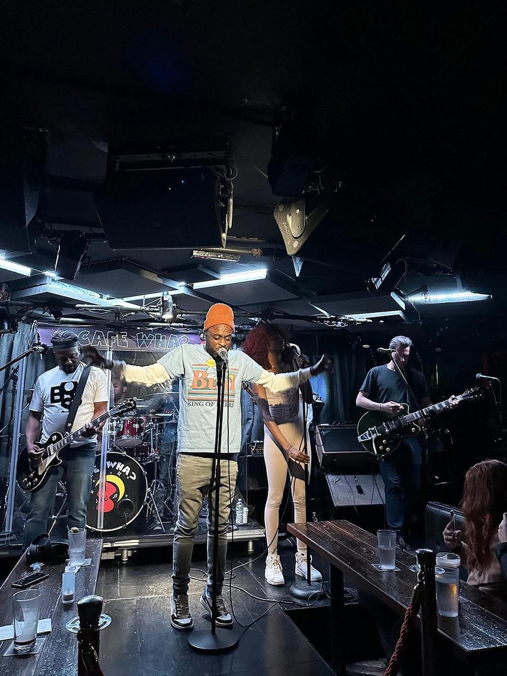 Vibrant live band performance at a music venue, showcasing talented musicians and energetic atmosphere.