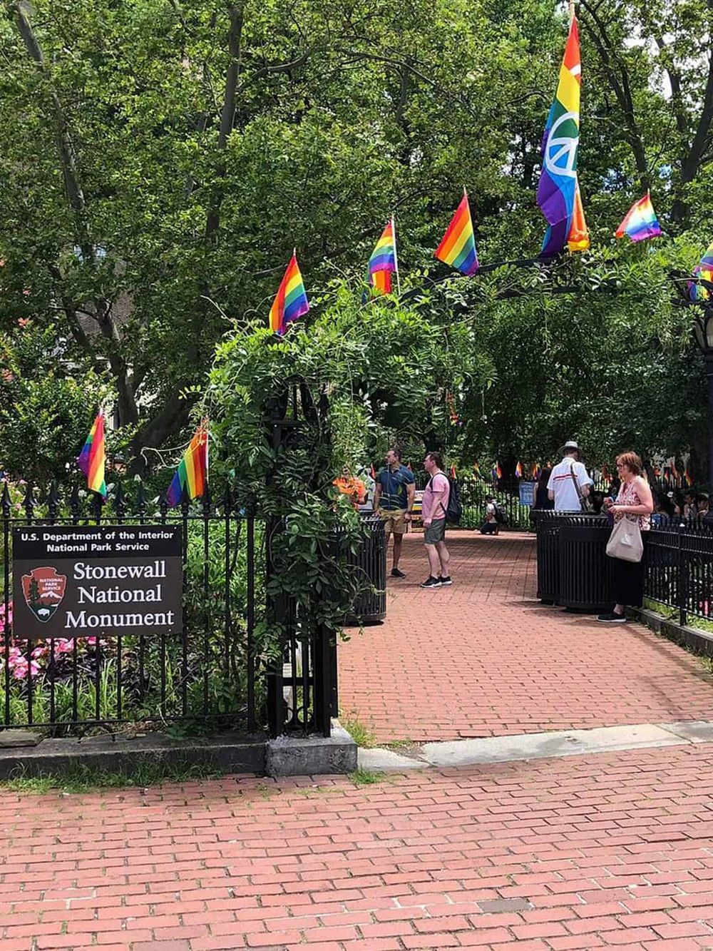 Colorful rainbow flags at Stonewall National Monument, a historic site for LGBTQ+ rights and pride.