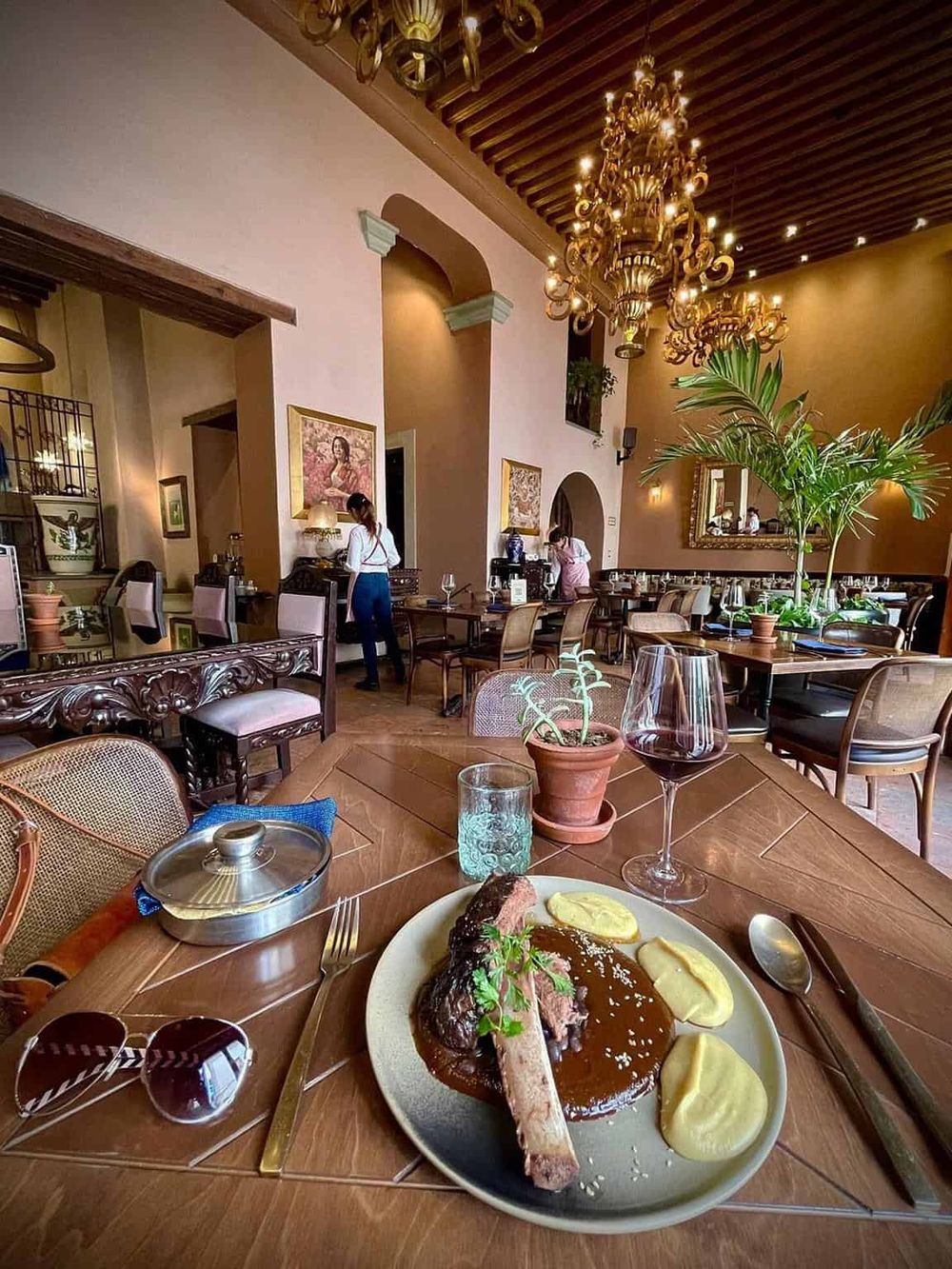 Elegant restaurant interior with plated meal, wine, and scenic decor, perfect for fine dining experience.