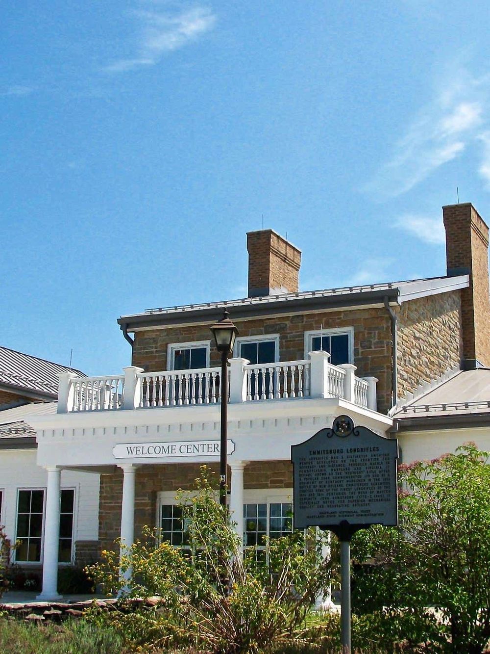 Chesapeake Longfellow historic building at the Welcome Center in Chesapeake, Virginia, with blue sky and greenery.