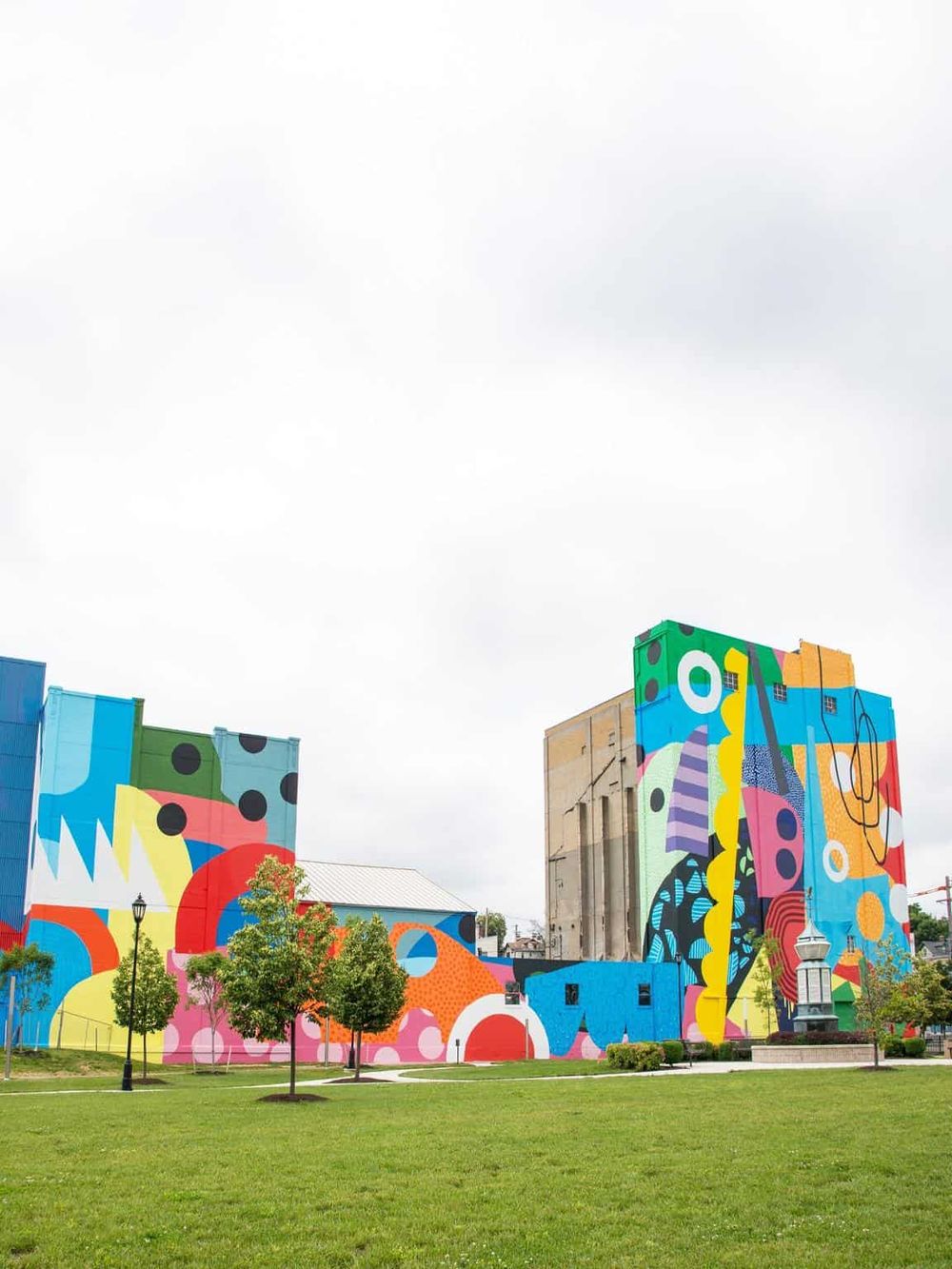 Colorful urban mural art on building exterior, vibrant cityscape with street art murals.