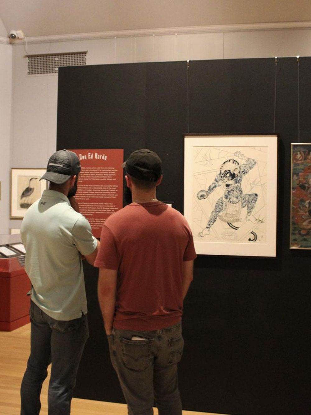 Vivid image of two men viewing art at a museum, promoting art appreciation and cultural exploration.