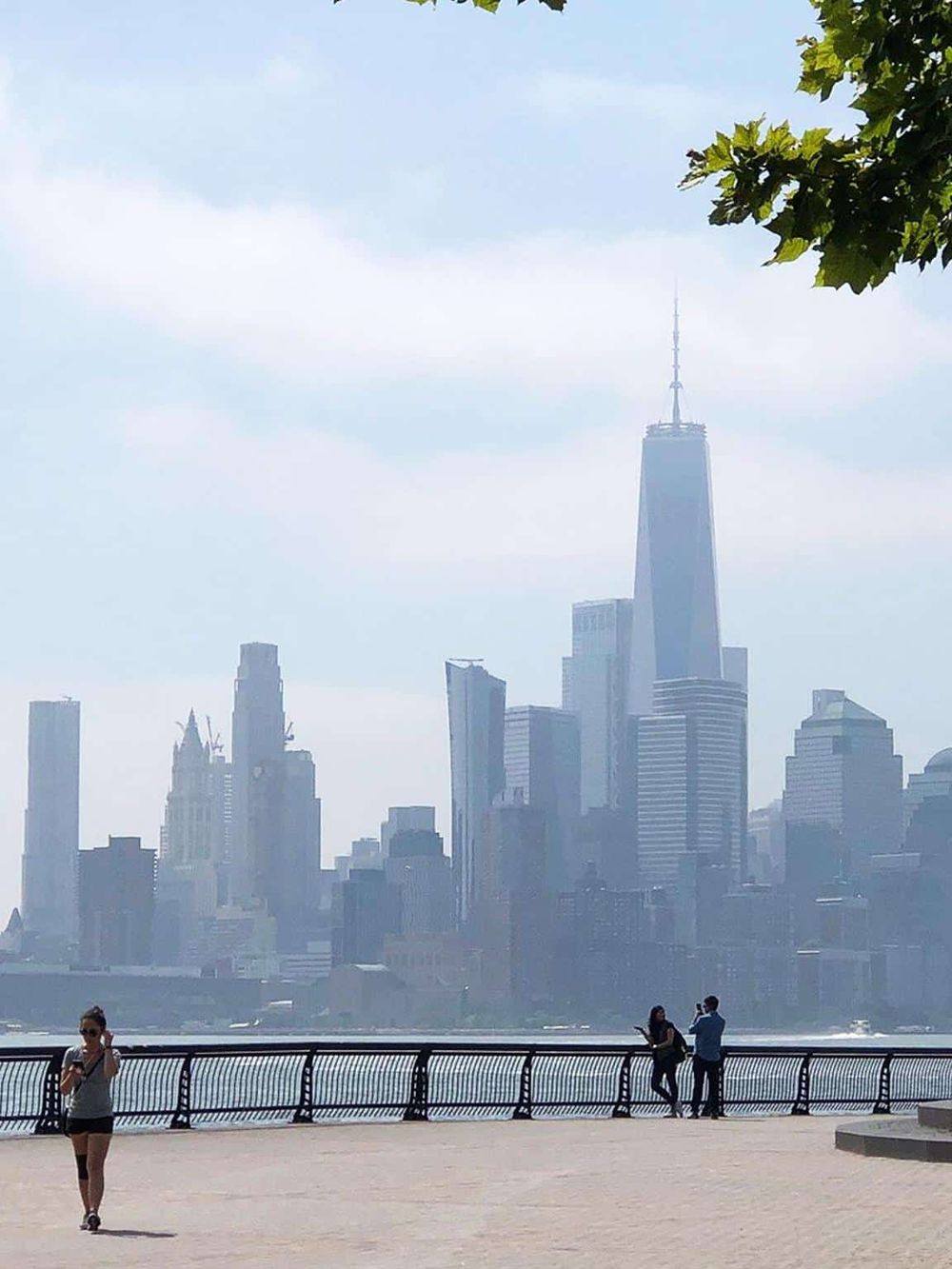 Stunning view of Manhattan skyline with One World Trade Center in New York City, featuring landmark architecture and cityscape.