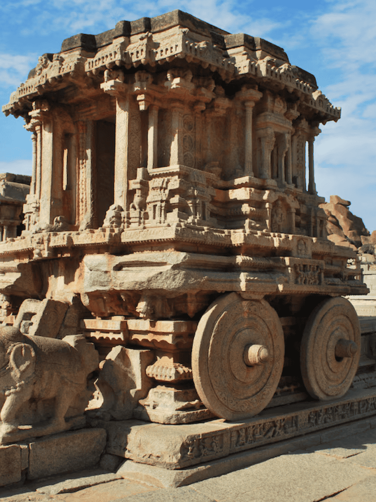 Ancient stone chariot at Hampi, India, showcasing historic temple architecture and carvings.