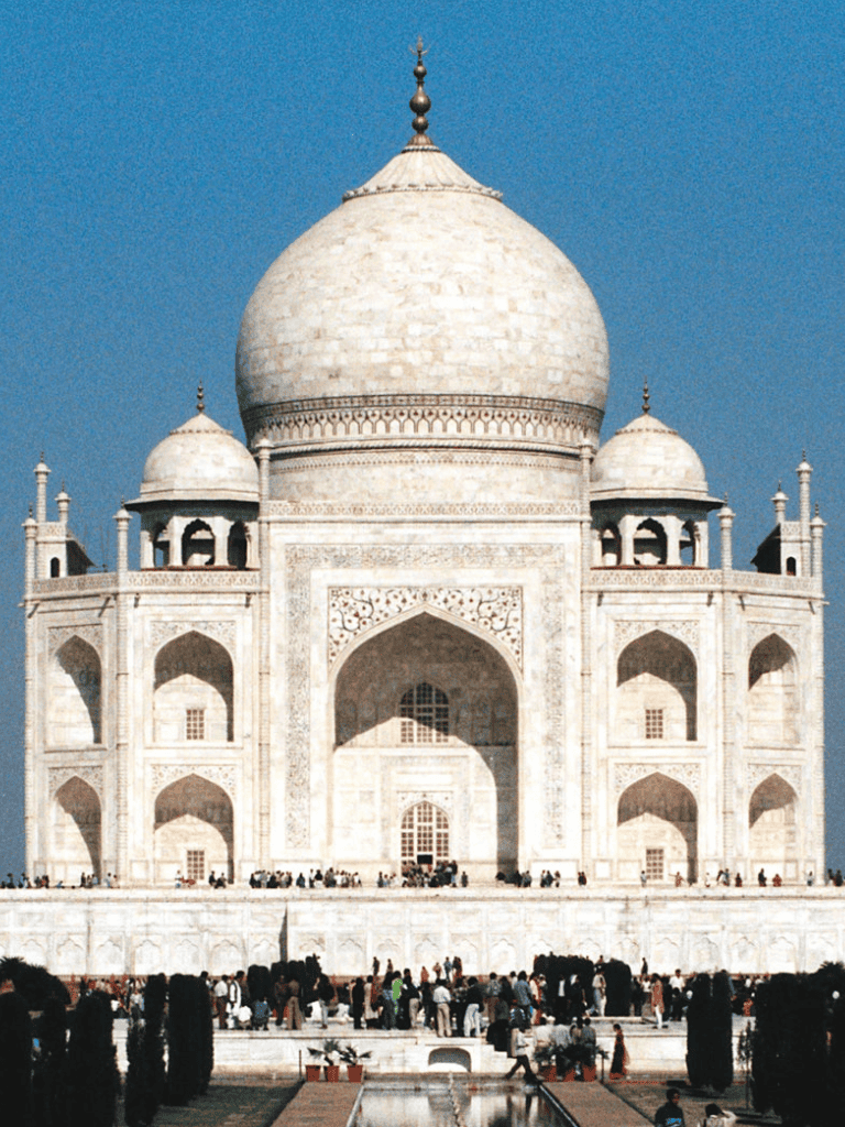 Majestic Taj Mahal monument in India with intricate marble architecture and iconic white domes.