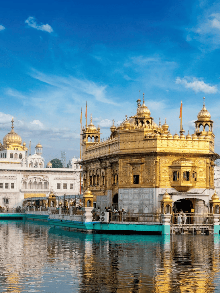Golden Sikh Gurdwara heritage architecture with water reflection in Amritsar, India.