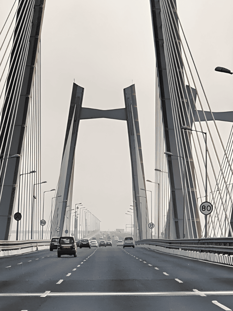 High-rise bridge with multiple lanes and modern cable-stayed design, urban traffic scene.