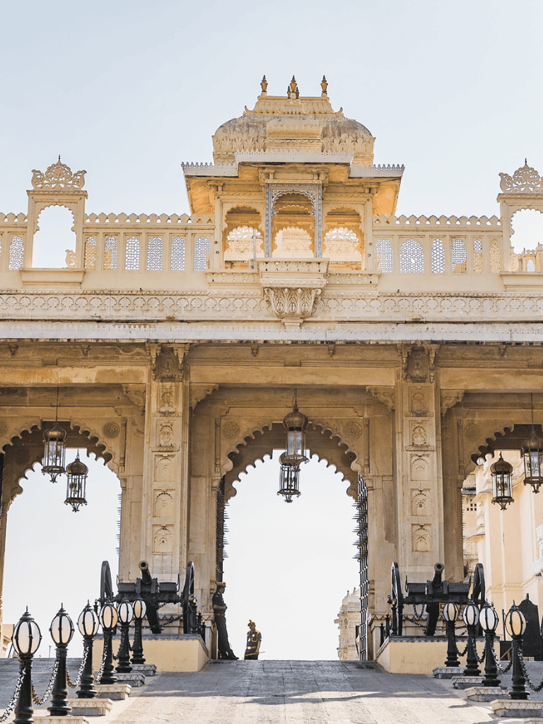 Intricate Rajasthan palace entrance with traditional architecture and hanging lanterns, showcasing Indian heritage and historical grandeur.