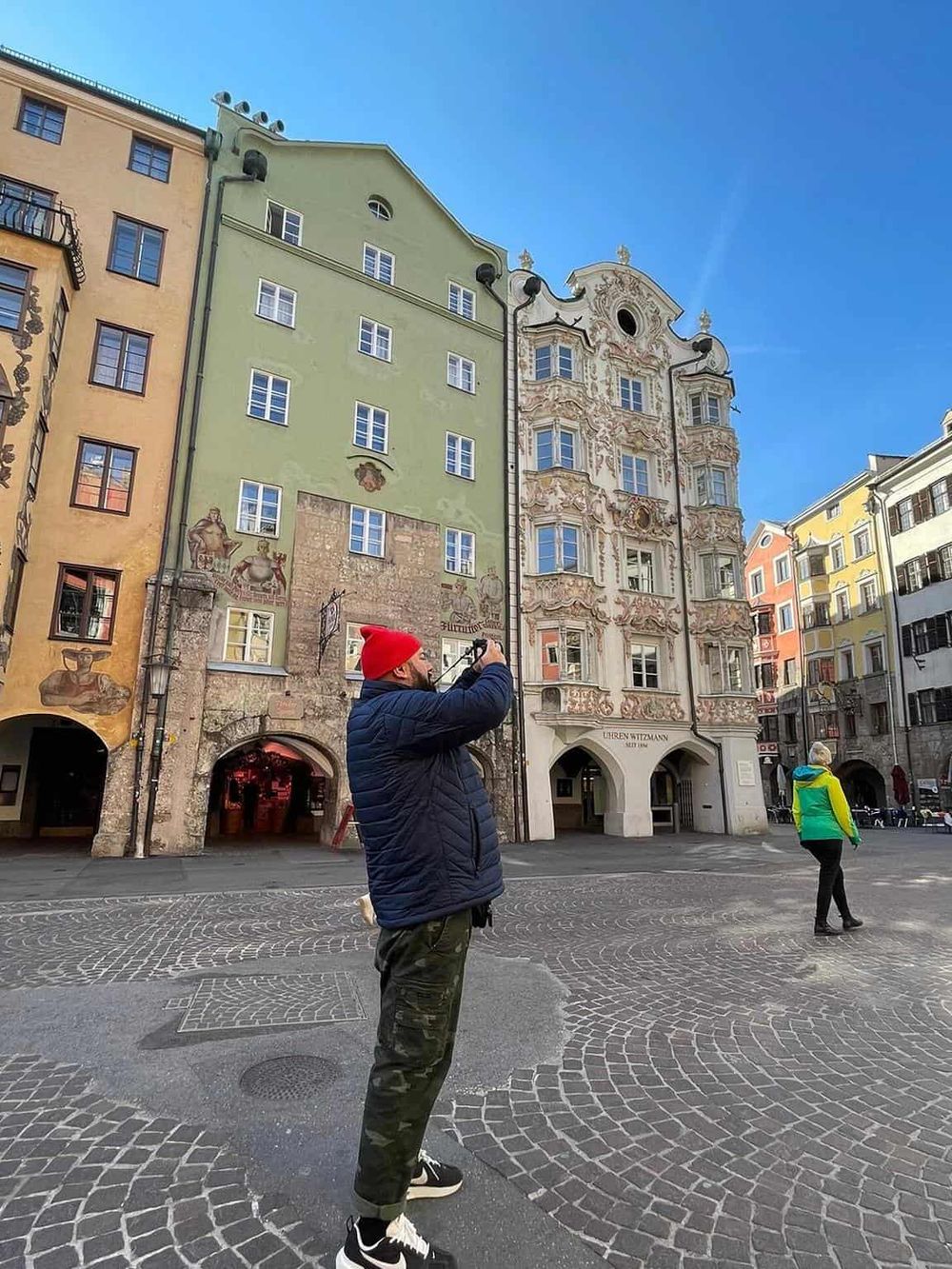 Colorful historic European buildings with intricate architecture and street scene in Salzburg, Austria.