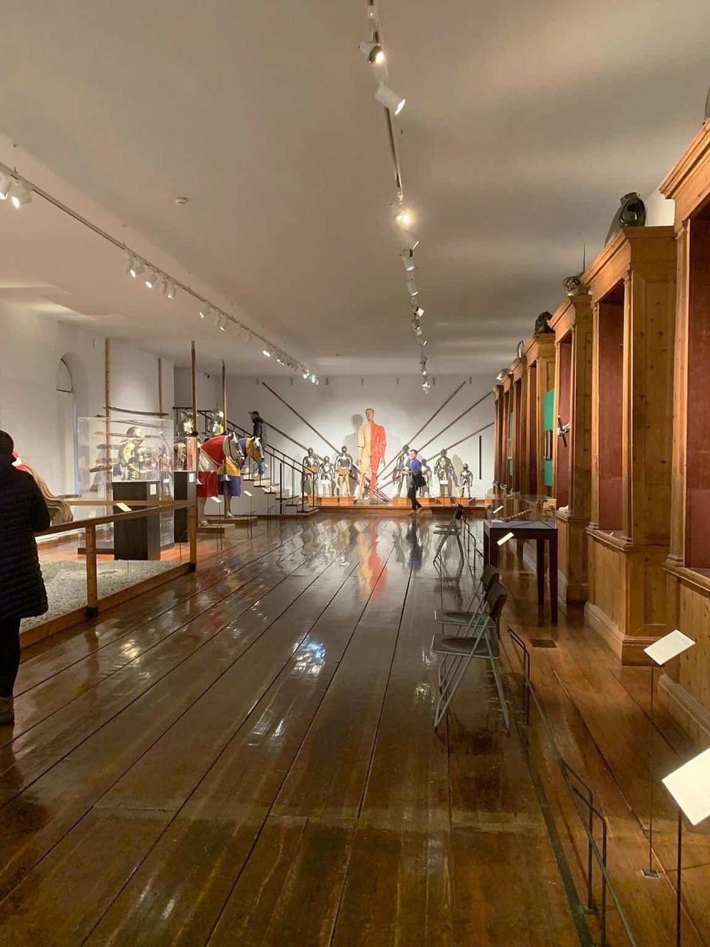 Museum exhibit showcasing historical mannequins and artworks in a spacious gallery.