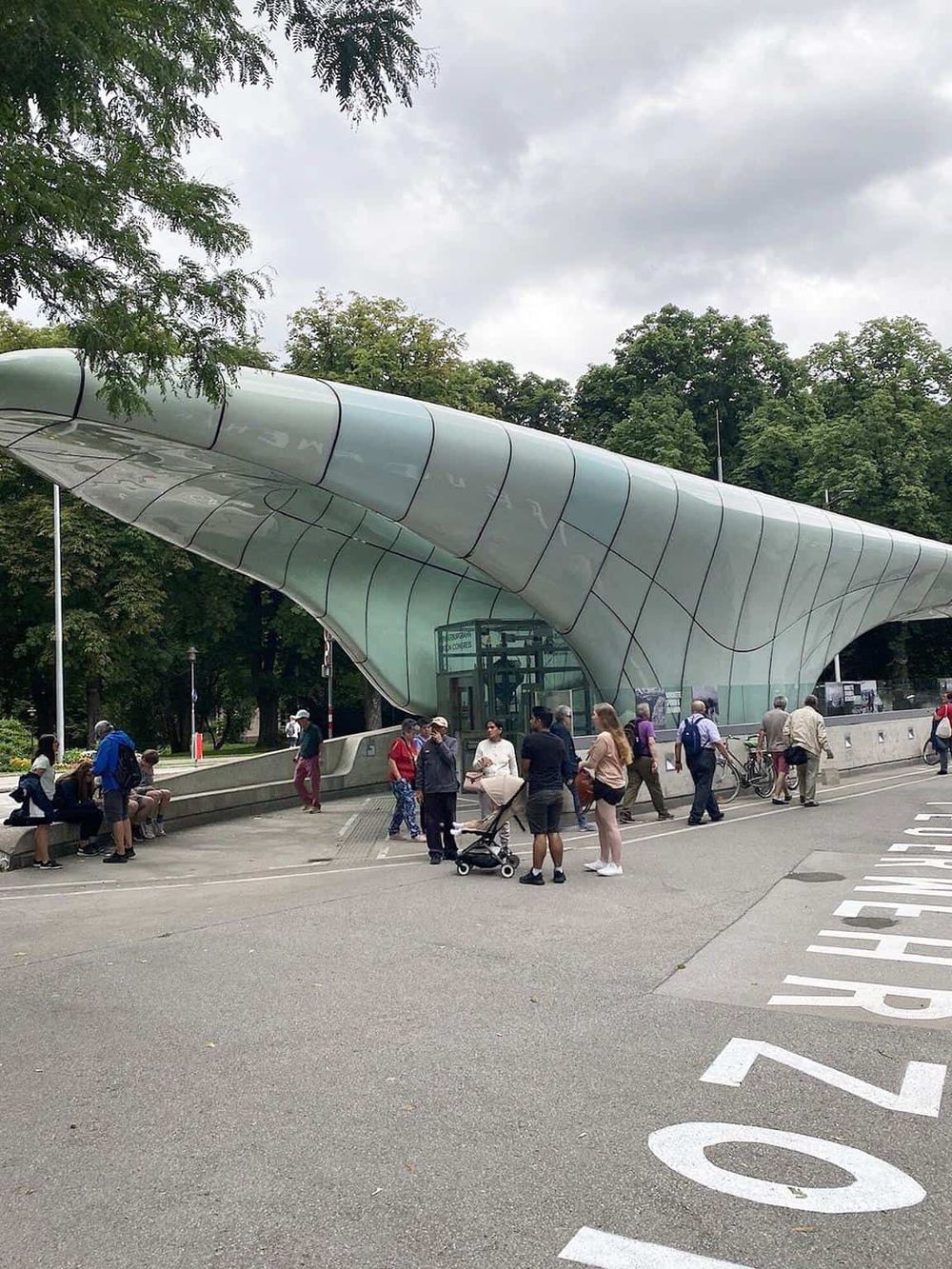 Modern architectural structure at QuestForDirections, urban setting with people gathering.