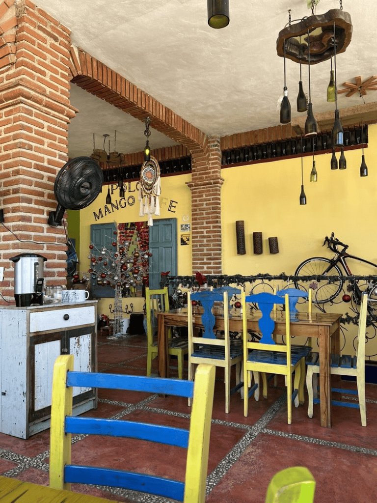 Colorful cozy restaurant interior with brick pillars and eclectic decor, perfect for family dining and celebration.