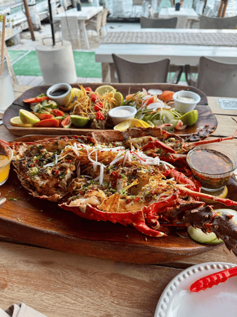 Fresh lobster feast with sides and sauces at QuestForDirections restaurant.