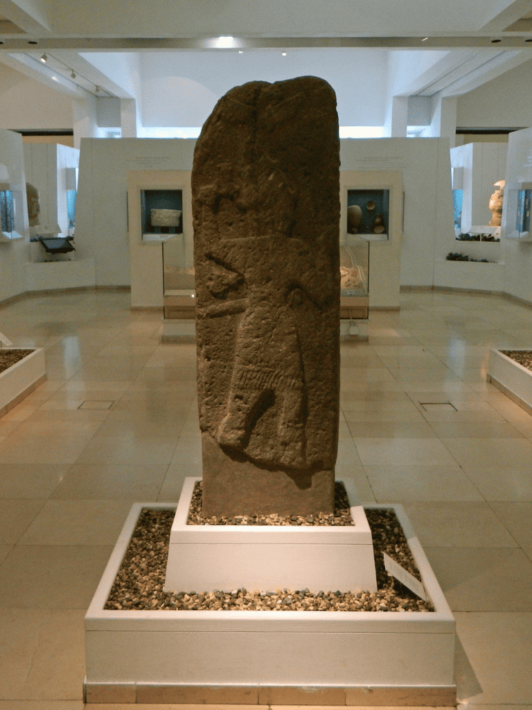 Ancient carved stone artifact at QuestForDirections museum display.