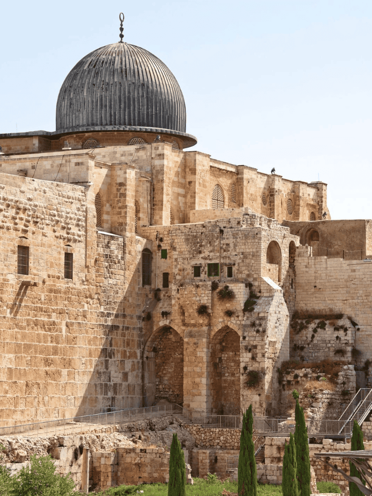 Ancient stone fortress with a domed roof and greenery, showcasing historic architecture and Jerusalem's cultural heritage.