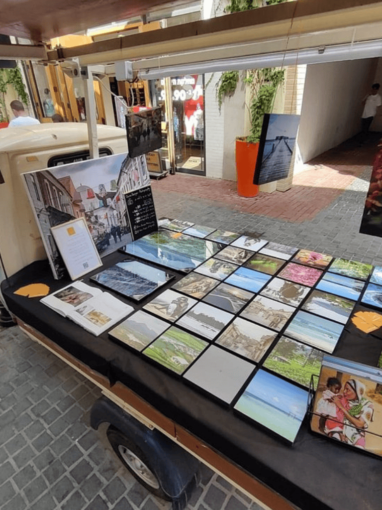 Aerial view of outdoor art display and travel brochures at QuestForDirections, showcasing local scenery and travel guides.