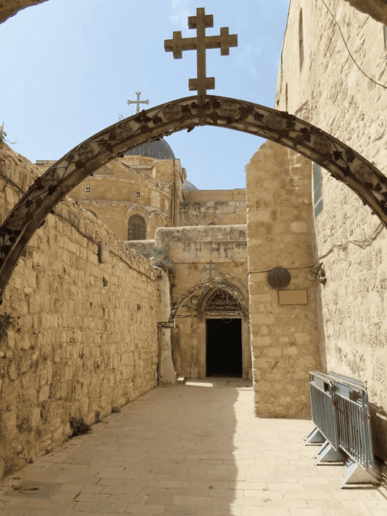 Ancient Christian church in Jerusalem under a blue sky with stone architecture.