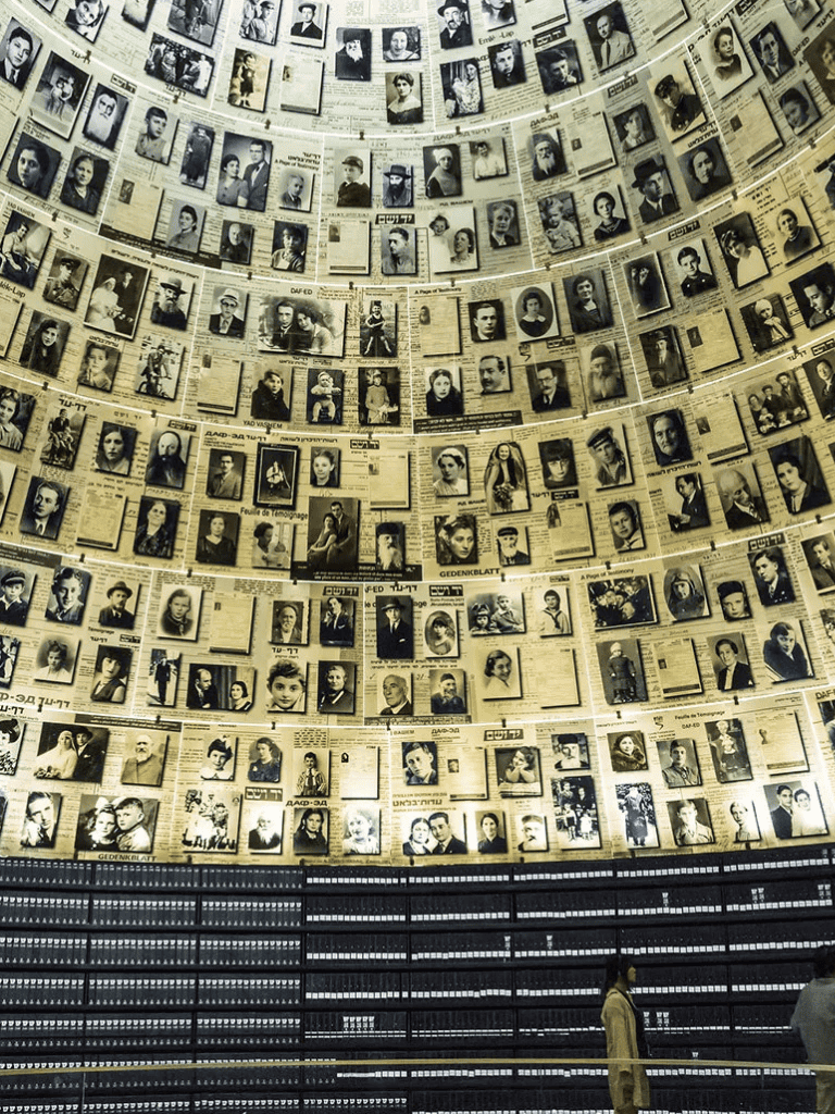 Photographs of Holocaust victims displayed in a memorial exhibit, emphasizing remembrance and historical education.